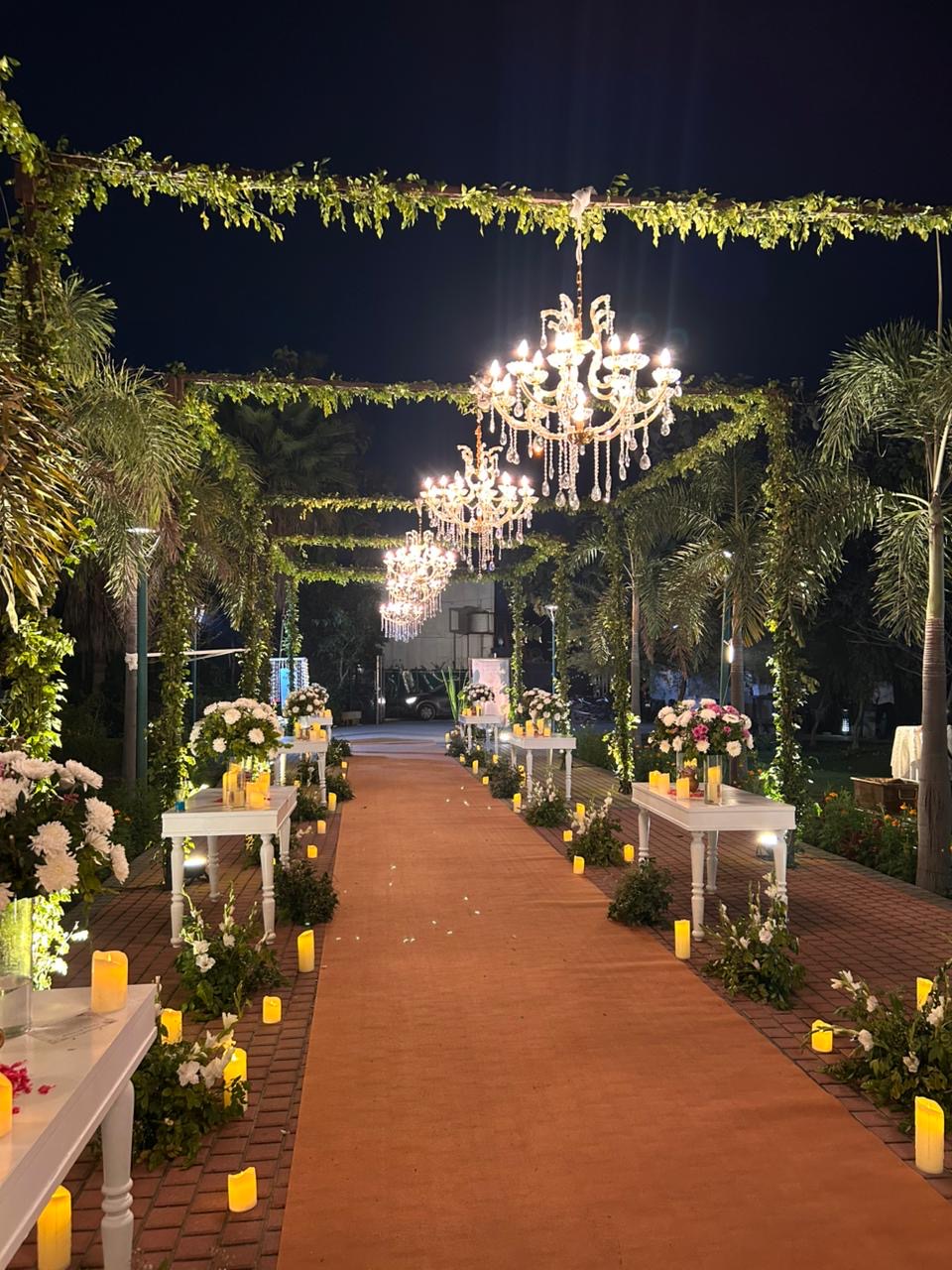 Chandelier-lit palace wedding walkway in Udaipur, designed by Saffron Collective